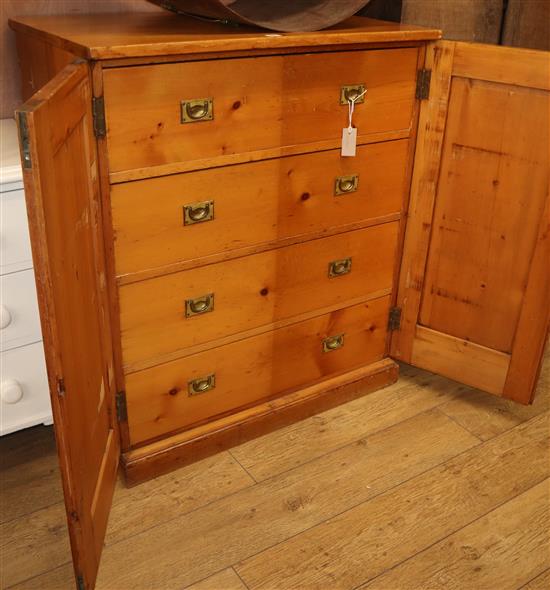 A pine cupboard with fitted campaign handle drawers W.92cm